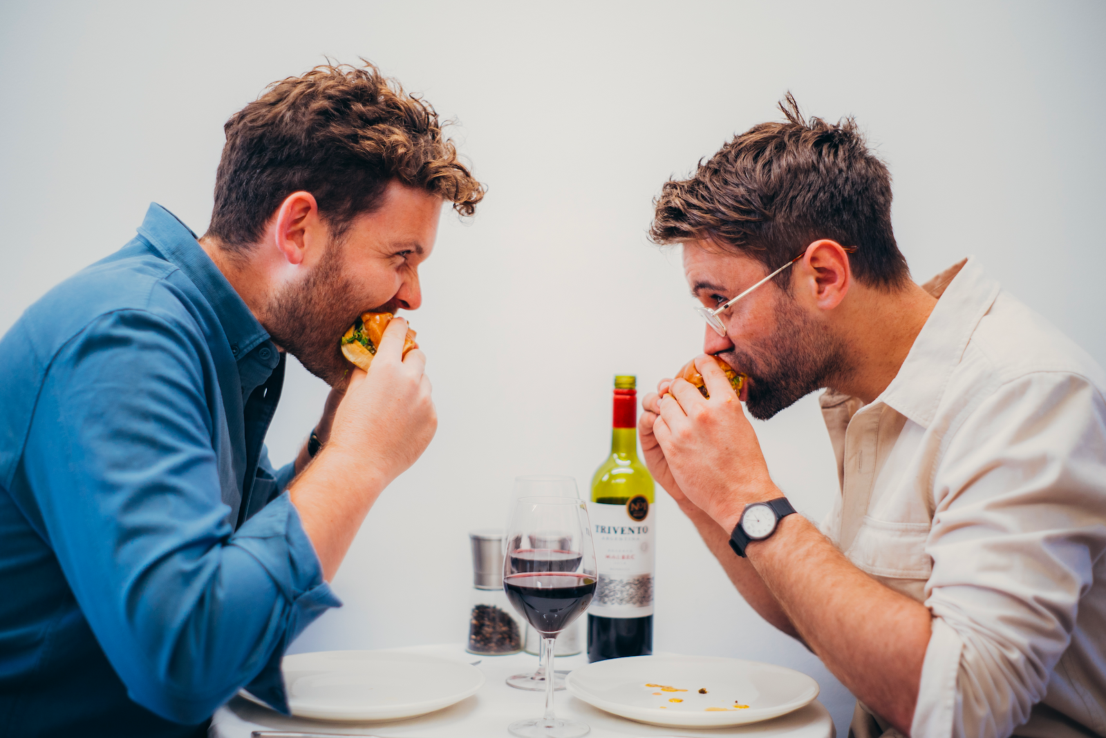 Digby Vollrath and Hugo Campbell, founders of Feast It, eating a burger