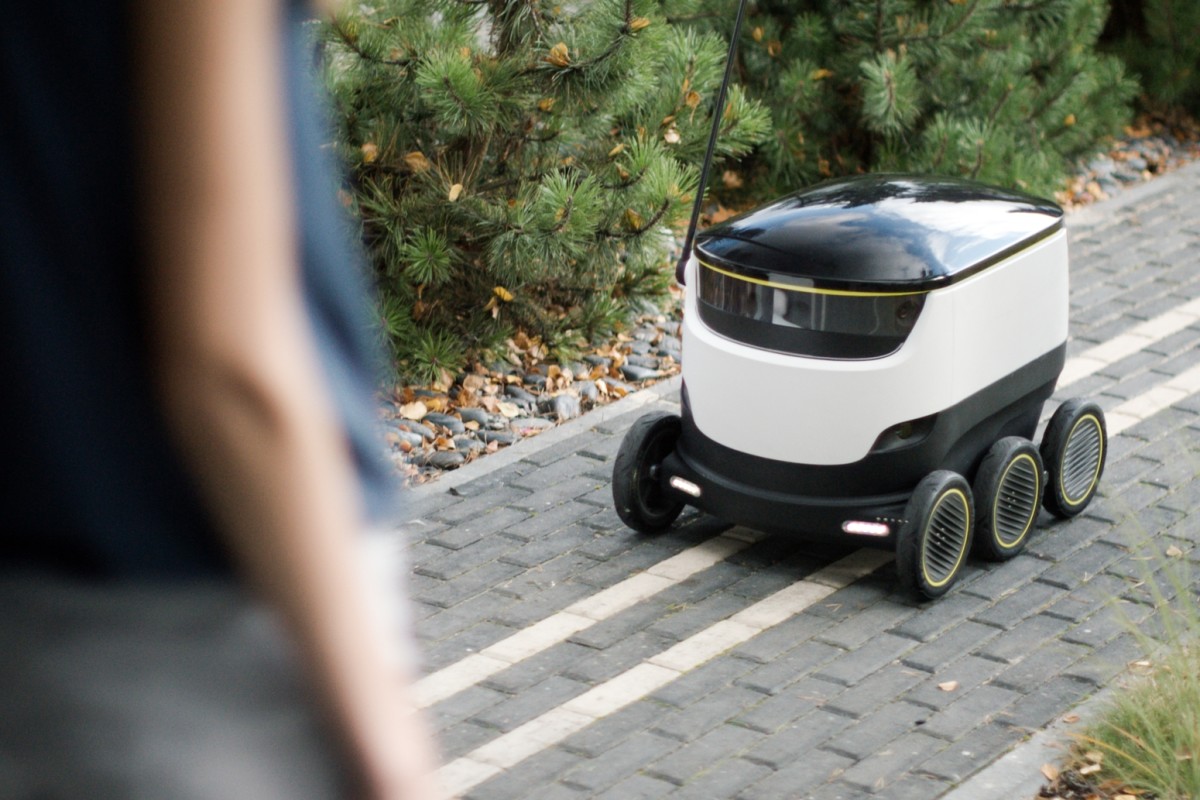 food delivery robot driving on the street